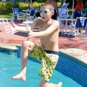 Kid jumping into a pool